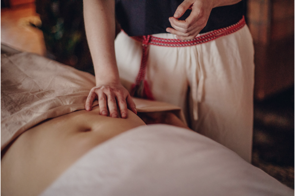 woman holding a soft hand on a clients stomach